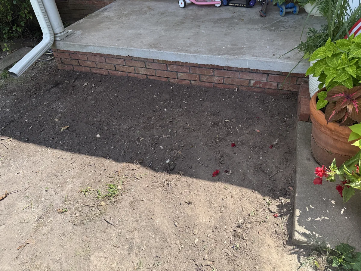 After root and stump cleanup along a front porch bed